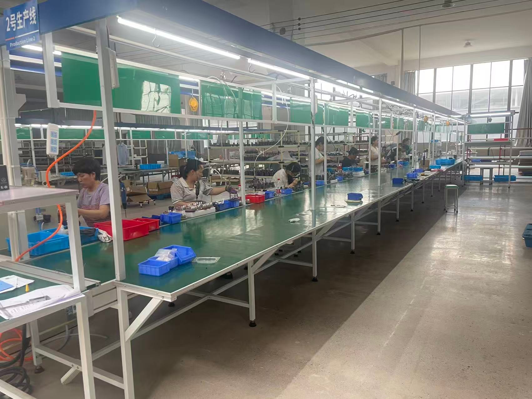 HALEE team members working along a production assembly line